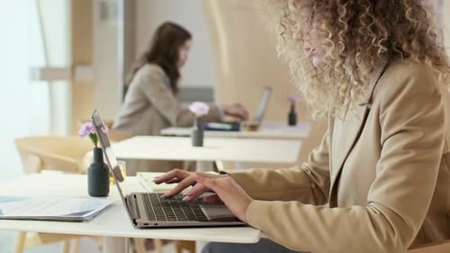 Two Businesswomen Working on Computers in Office