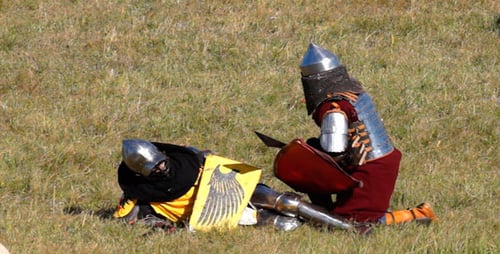 Medieval Battle Reenactment on Grassy Field