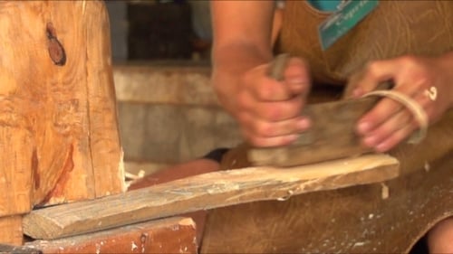 Woodworker Smoothing Plank with Hand Plane