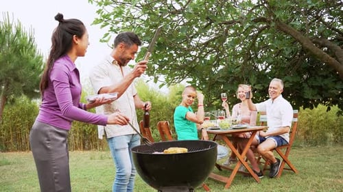 Friends Enjoying a Relaxing Barbecue in Garden