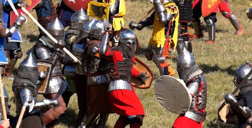 Men Engaged in Historical Battle Reenactment in Field