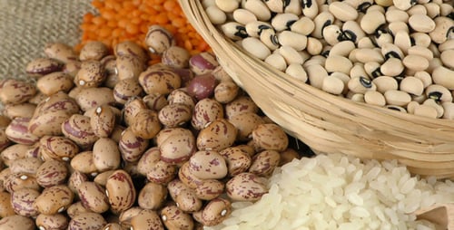 Varied Grains and Legumes on Burlap Background
