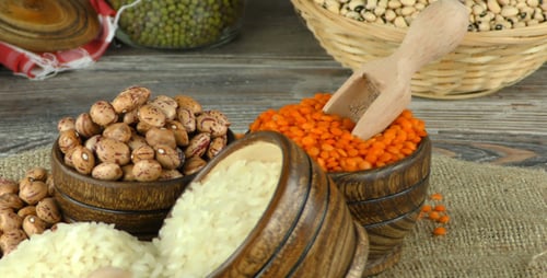 Colorful Bowls and Baskets of Raw Lentils, Beans, and Rice