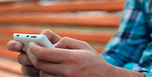 Man Using Mobile Device in Urban Setting