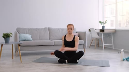 Woman Exercising, Stretching Torso at Home