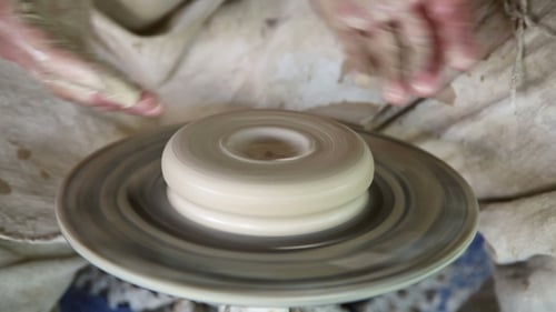 Potter Sculpts Clay Small Pot