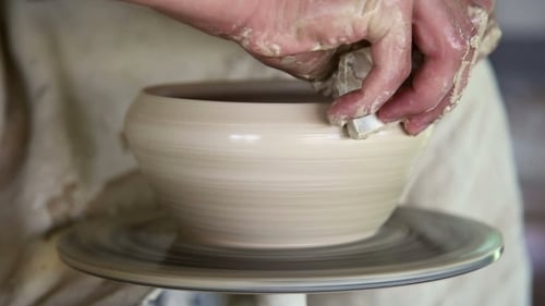 Potter Shaping Clay Bowl on Pottery Wheel