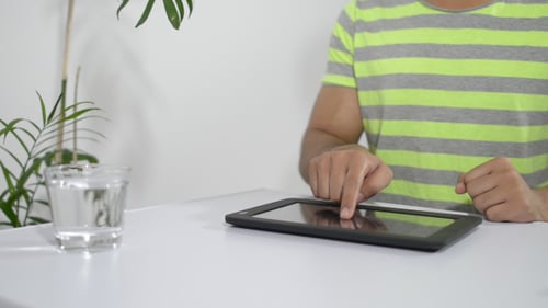 Man Using a Tablet Device Indoors at Home