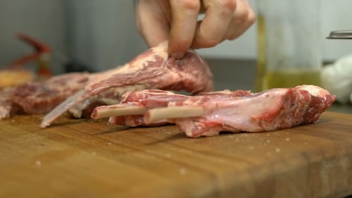 Raw Marbled Ribs Being Sorted on a Cutting Board