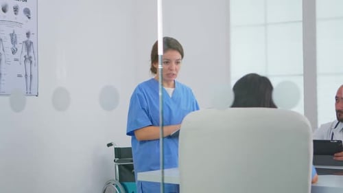 Doctor Discusses Patient Care in Bright Medical Office