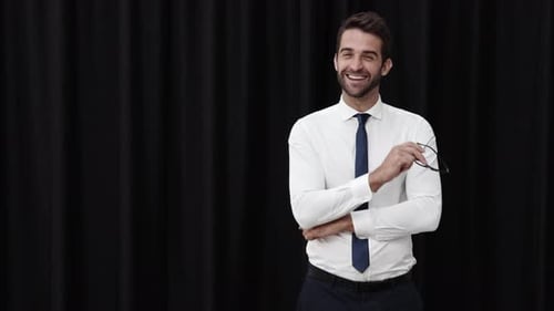 Bearded Man Takes off Glasses and Smiles