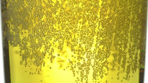 Bubbles Rising in Yellow Beverage
