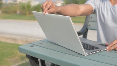 Laptop öffnen, tippen und schließen, im Park