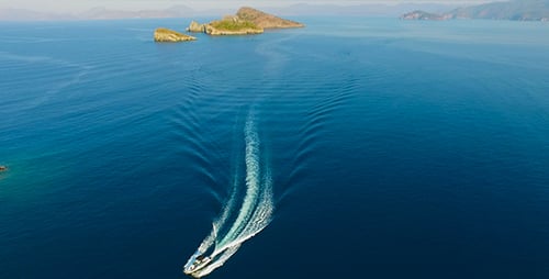 Speedboat Glides on Turquoise Ocean Aerial View