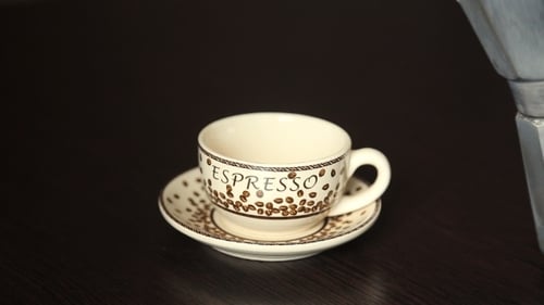 Pouring Hot Coffee into Espresso Cup