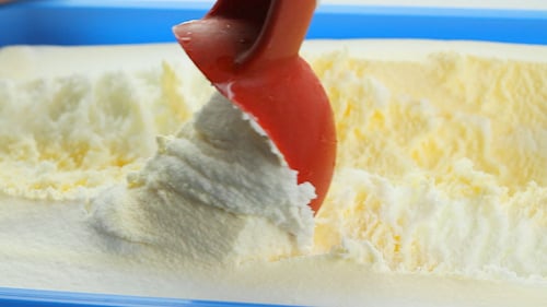 Scooping Creamy Ice Cream from Container