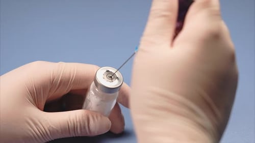 Close Up Of Filling Syringe With Medication