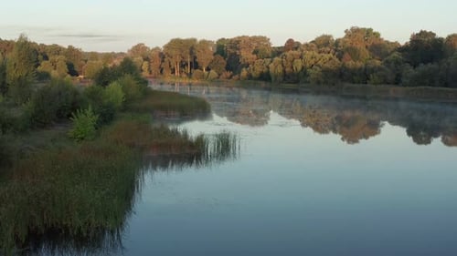 Beautiful morning, summer flight over the river. Fog, trees.