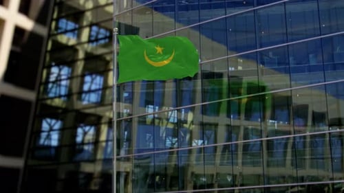 Mauritania Flag Waving in Front of Modern Corporate Building