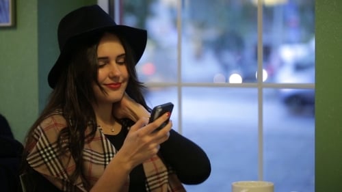 Young Beautiful Woman Sitting In Cafe And Read