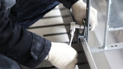 Worker To Tighten The Screws