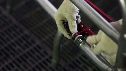 Man Wearing Gloves Tighten The Bolt And Nut