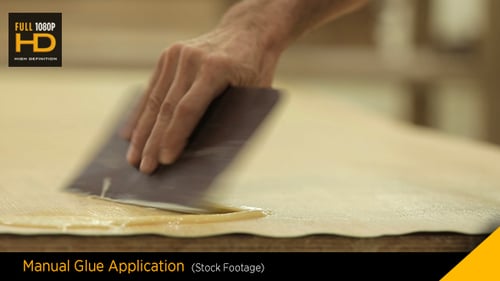 Applying Clear Liquid with Tool on Beige Surface