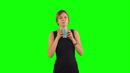 Woman drinking from mug on green screen