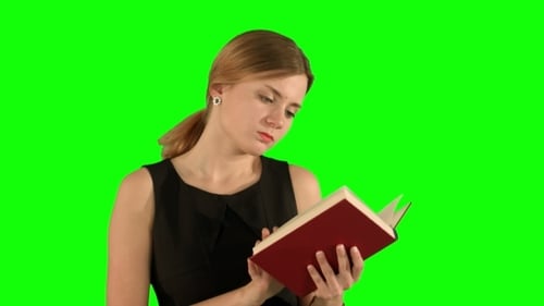 Young Beautiful Girl Reading a Book On Laptop On a