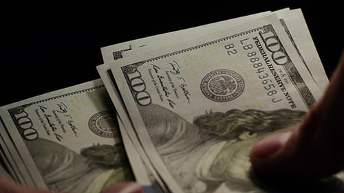Person Counting One Hundred Dollar Bills Close Up