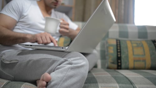 Young Adult Working on Laptop at Home Indoors