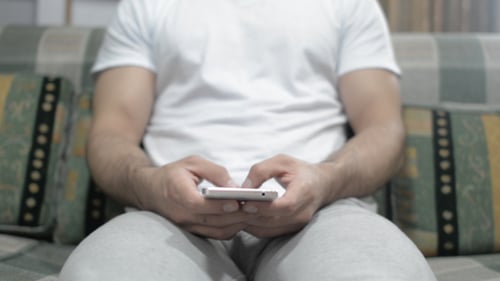 Casual Man Typing on smartphone