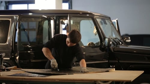 Man Working on Car in Workshop