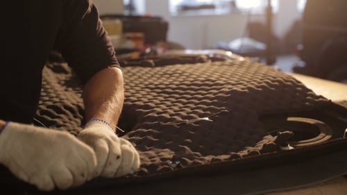 Mechanic Working on Auto Part with Gloves On