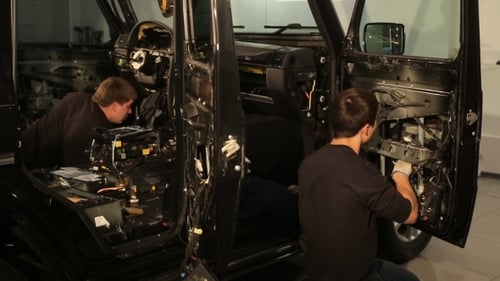 Men Repairing Interior of SUV in Garage