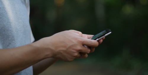 Person Using a Smartphone in Nature