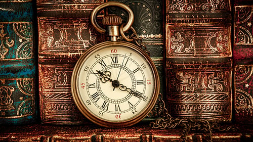 Vintage Pocket Watch with Antique Books Behind