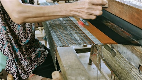 Skilled Weaver at Work on a Traditional Loom