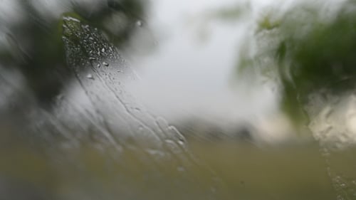 Rain Droplets on a Wet Glass Surface