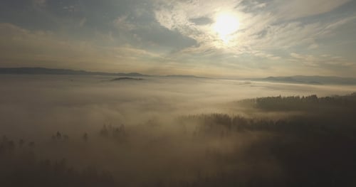 Aerial View of Foggy Landscape at Sunrise