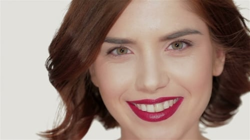 Woman with Auburn Hair and Red Lipstick Smiling