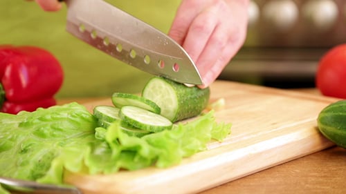 Slicing Cucumber in Kitchen for Healthy Eating