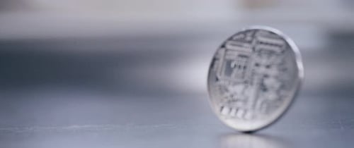 Macro Shot of Silver Coin Spinning on Surface