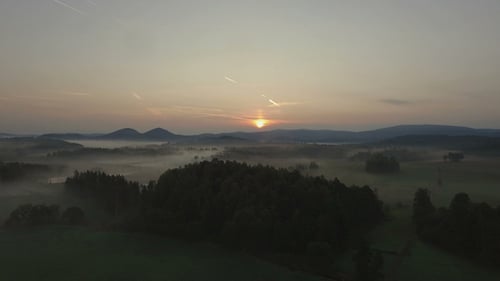 Sunrise Over Foggy Fields and Forests