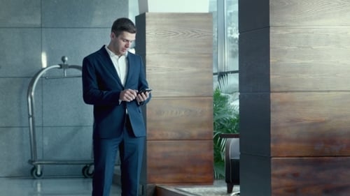 Business Man Using Smartphone in Modern Building