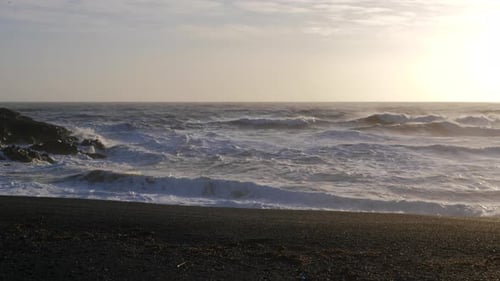 Iceland Beautiful Black Sand Beach Ocean Shoreline On Sunny Day