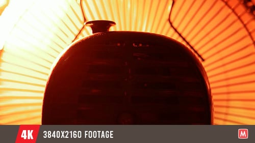 Vintage Black Fan Spinning with Orange Glow