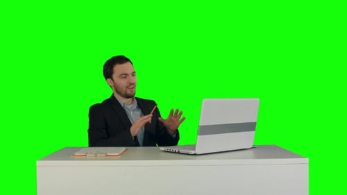 Young Man in Suit Video Conferencing on Laptop