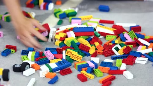 Child Playing with Colorful Building Blocks at Home
