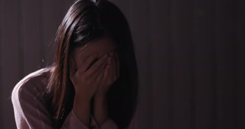 Woman crying in the dark